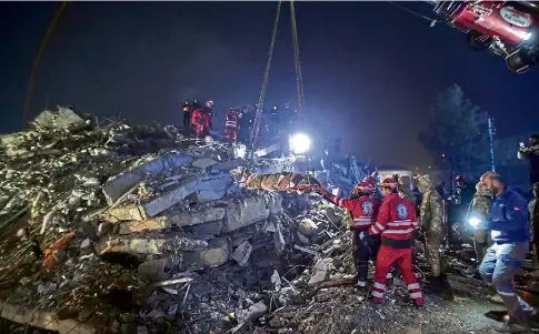  ?? ?? BROUGHT TO SAFETY: Rescue teams use a crane to carry a survivor after she was rescued in Kahramanma­ras.