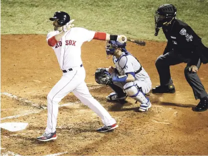  ?? AP ?? J. D Martínez expande sus brazos y conecta un sencillo remolcador de dos vueltas en el partido que ganaron los Medias Rojas anoche.