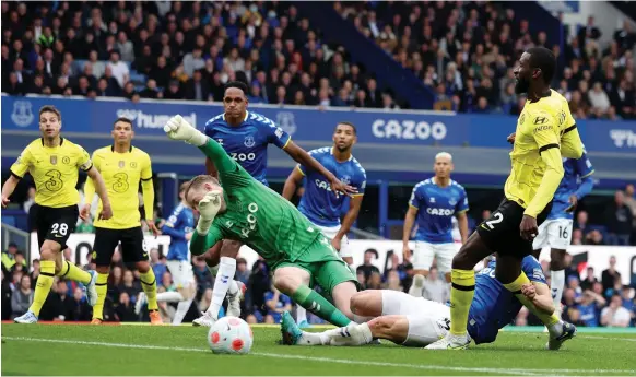  ?? Reuters ?? Everton goalkeeper Jordan Pickford saves a shot from Chelsea’s Antonio Rudiger with his face during yesterday’s match at Goodison Park