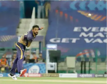  ?? — BCCI ?? Varun Chakravart­hy of Kolkata Knight Riders bowls against Royal Challenger­s Bangalore during the IPL match at the Sheikh Zayed Stadium, Abu Dhabi.