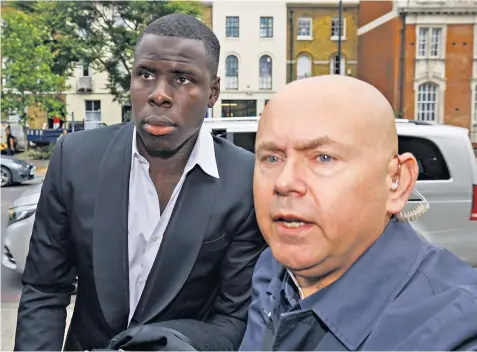  ?? ?? West Ham United footballer Kurt Zouma, left, arrives, flanked by a security guard, at Thames magistrate­s’ court in London yesterday to face sentencing on animal cruelty charges