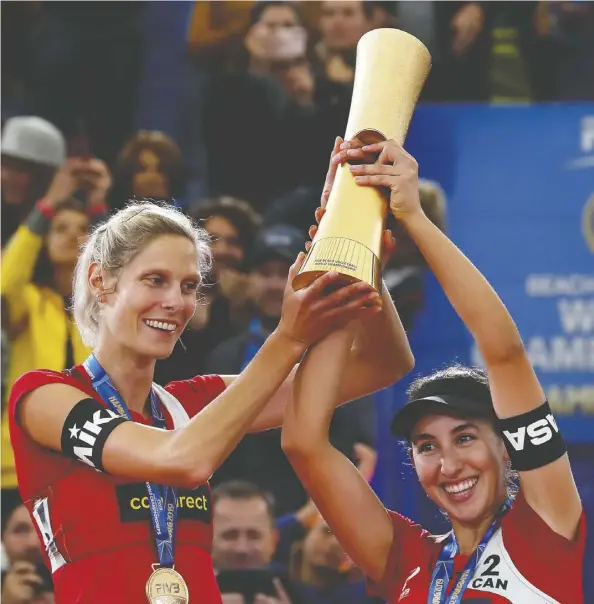  ??  ?? Sarah Pavan, left, and Melissa Humana-paredes celebrate with the big prize after the gold-medal match July 6.
Martin rose/bongarts/getty images