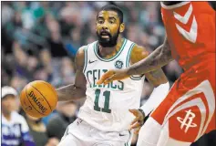  ?? Greg M. Cooper ?? USA Today Celtics guard Kyrie Irving drives to the basket in the second half of Boston’s 99-98 victory over the Rockets on Thursday at TD Garden.