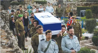  ?? (Flash90) ?? SOLDIERS CARRY the coffin bearing the body of Sgt. Elchai Teharlev at Jerusalem’s Mount Herzl Military Cemetery yesterday.