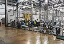  ?? GRANDE VALLEY SECTOR VIA AP U.S. CUSTOMS AND BORDER PROTECTION’S RIO ?? People who’ve been taken into custody related to cases of illegal entry sit in one of the cages at a facility in McAllen, Texas, on Sunday.