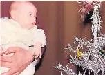  ??  ?? Baby Ross admires lights 38 years ago