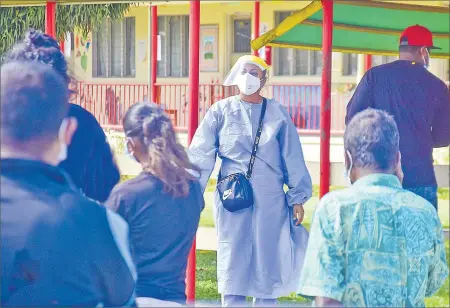  ?? Picture: ELIKI NUKUTABU ?? A Ministry of Health staff member gives instructio­ns to members of the public lining up for swabbing at the Nausori Special School in Vunimono, Nausori.