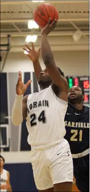  ?? RANDY MEYERS — FOR THE MORNING JOURNAL ?? Seth Wilson of Lorain drives by Xen Borden of Garfield Heights and scores during the first quarter Feb 13.