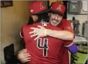  ?? MORRY GASH — THE ASSOCIATED PRESS ?? Arizona manager Torey Lovullo and Ketel Marte celebrate after beating Milwaukee to win their wild-card series.