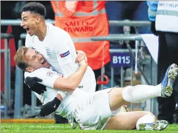  ??  ?? England's striker Harry Kane lies on the floor as England's midfielder Jesse Lingard (up) celebrates after Kane scores their second goal during the internatio­nal UEFA Nations League football match between England and Croatia at Wembley Stadium in London