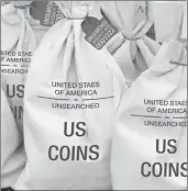  ??  ?? UNSEARCHED: Pictured above are the unsearched Vault Bags loaded with over 2 pounds of U.S. Gov’t issued coins some dating back to the 1800’s being handed over to Illinois residents.