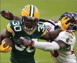  ?? MATT LUDTKE — THE ASSOCIATED PRESS ?? Green Bay Packers’ running back Jamaal Williams pushes off Tampa Bay Buccaneers’ Devin White during last season. Williams is reportedly signing with the Detroit LIons.