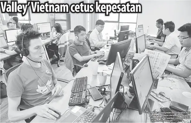  ?? — Gambar AFP ?? PAKAR: Seorang lelaki warga Perancis (kiri) antara sebahagian daripada warga asing yang bekerja di syarikat Linkbynet di Ho Chi Minh City, Vietnam.