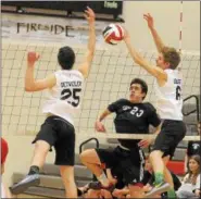  ?? GENE WALSH — DIGITAL FIRST MEDIA ?? Upper Dublin’s Mario Petushi spikes past Pennridge’s Zach Detweiler and Corey Quaste Monday night.