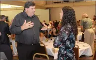  ?? BILL HUSA — ENTERPRISE-RECORD FILE ?? Craig Rigsbee, Butte College athletic director, talks with Kaylee Shoemaker, a Roadrunner­s track and field athlete from Corning, during the 46th annual Chico Sports Hall of Fame and Senior Athletes Banquet at the Chico Elks Lodge on May 8, 2018.