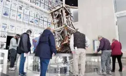  ??  ?? Visitors look at a section of the television antenna that once sat atop the World Trade Center’s north tower, at the Newseum.