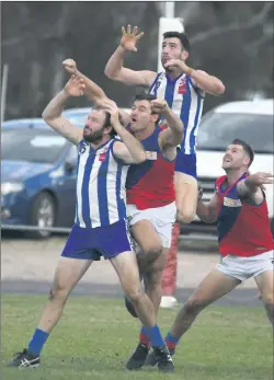  ??  ?? UP WE GO: Simon Close flies over Daniel Launer and James Staude during a Horsham District football clash between Harrow-balmoral and Kalkee at Harrow.
Picture: PAUL CARRACHER