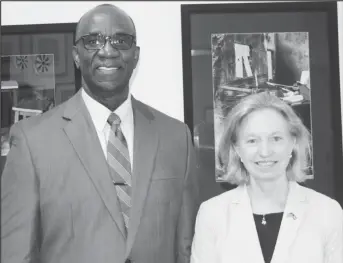  ?? Embassy photo) (US ?? Dr. Norman Munroe (left) with US Ambassador Sarah-Ann Lynch