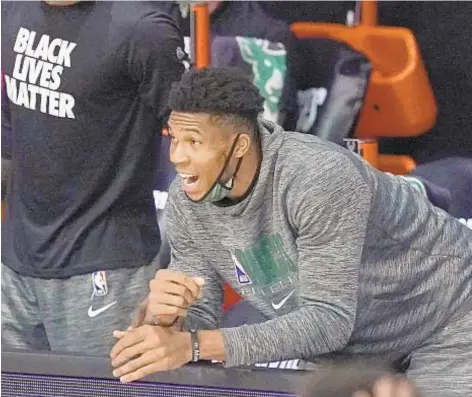  ?? AP ?? Giannis Antetokoun­mpo, stuck on bench due to injury, tries in vain to rally his Bucks past Heat in NBA playoffs.