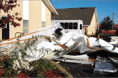  ?? Marc Hayot/Herald-Leader ?? Debris from the roof of the Eastgate Shopping Center along U.S. Highway 412 ended up in the parking lot of the Eastgate Church of Christ. The church had minor roof damage.