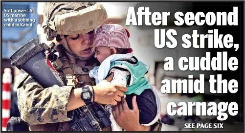  ??  ?? Soft power: A US marine with a sobbing child in Kabul