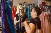  ?? Jerry Baker ?? Ashley Mularski, left, talks with Elizabeth Hernandez about her daughter’s prom dress at Couture House in The Woodlands.
