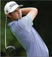  ?? (AP/Charlie Neibergall) ?? J.T. Poston hits a tee shot on No. 2 in the second round of the John Deere Classic on Friday at TPC Deere Run in Silvis, Ill. Poston leads the field by three strokes at 15 under heading into today’s third round.