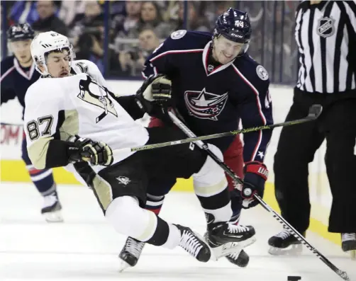  ??  ?? OHIO: Pittsburgh Penguins’ Sidney Crosby (left) collides with Columbus Blue Jackets’ Justin Falk during the first period of an NHL hockey game on Friday, Nov 27, 2015, in Columbus, Ohio. —AP