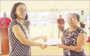  ?? ?? Minister of Tourism Industry and Commerce Oneige Walrond (left) handing over a cheque to a recipient