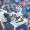  ?? ADRIAN KRAUS AP ?? Bills QB Nathan Peterman is sacked by Chicago’s Isaiah Irving and Nick Williams.