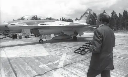  ?? (Chananya Herman/GPO) ?? THEN-PRIME minister Menachem Begin looks at an F-16 fighter jet used in the attack on the Osirak nuclear reactor, in 1981.