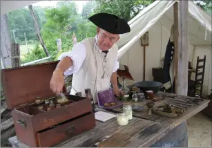  ?? Photos by Jamestown-Yorktown Foundation ?? AT LEFT: A Continenta­l Army surgeon in the surgeon's tent at the American Revolution Museum at Yorktown's Continenta­l Army encampment in Yorktown, Va.