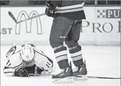  ?? Billy Hurst
Associated Press ?? ANZE KOPITAR lies on the ice after getting hit Tuesday in the face by the butt end of Ryan Reaves’ stick. He missed two periods after the hit.