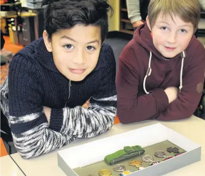  ?? PHOTO: LOGAN SAVORY ?? Awarded for valour . . . Dion WyattTaual­ofa (9, left) and Dylan Corkhill (10) check out Dick Travis’ war medals, including the Victoria Cross, at the Invercargi­ll Public Library. Yesterday was 100 years to the day that Mr Travis died at war in France.