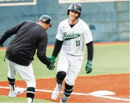  ?? WRIGHT STATE ATHLETICS PHOTO ?? Wright State’s Sammy Sass (11) is congratula­ted after hitting a home run earlier this season. Sass cracked four home runs on Tuesday in the Raiders’ 22-21 loss to Miami.