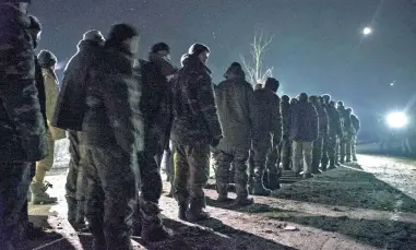  ?? GOING HOME: Ukrainian prisoners of war stand during a prisoner exchange of Ukrainian troops and separatist­s rebels in the eastern Ukrainian city of Frunze, near Luhansk.
PICTURE: EPA ??
