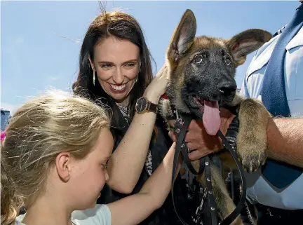  ?? PHOTO: ROSS GIBLIN/STUFF ?? Devon Cross, 9, and Prime Minister Jacinda Ardern meet police dog pup Hana after yesterday’s graduation ceremony at Porirua Police College.