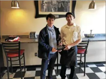  ??  ?? Princeton’s Aidan Trainor, left, is presented with the DeLorenzo’s “the Burg” CVC Player of the Year plaque. Trainor had 29 goals and 27 assists for the Little Tigers.