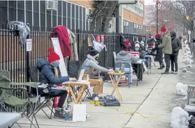  ?? Anthony Vazquez, Chicago Sun-Times via The Associated Press ?? Teachers prepare their desks and laptops for a virtual class outside of Suder Montessori Magnet Elementary School in Chicago on Jan. 11.