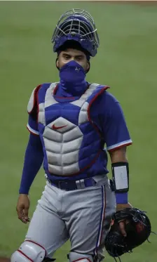  ?? AP PHoToS ?? MASKED BEHIND THE MASK: Rangers catcher Robinson Chirinos wears a mask during an intrasquad game.