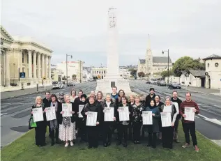  ?? PHOTO: REBECCA RYAN ?? Collasorat­ion, not competitio­n . . . Representa­tives from some of the 46 Oamaru susinesses taking part in ‘‘Qhoptoser’’ prepare to distrisute posters asout the town’s new shop local campaign.