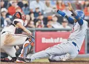  ?? George Nikitin
Associated Press ?? HANLEY RAMIREZ tries to score on a grounder to third base and is tagged out by Buster Posey.