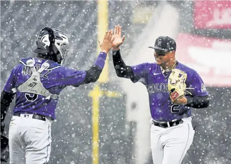  ?? Andy Cross, The Denver Post ?? Rockies catcher Dom Nunez, left, greets center fielder Yonathan Daza after the Rockies beat the Houston Astros 6-3 at Coors Field on a snowy Wednesday afternoon.