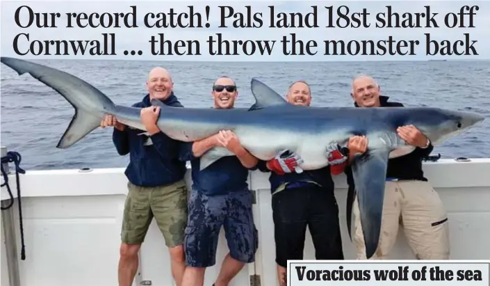  ??  ?? Hang on! The four friends pose with the blue shark before releasing it back into the sea