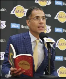  ??  ?? Los Angeles Lakers general manager Rob Pelinka reads a passage from “The Alchemist” by Paulo Coelho as he talks about the acquisitio­n of LeBron James and other free agents at a news conference at the NBA basketball team’s headquarte­rs in El Segundo, on...