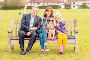  ??  ?? DCI John Barnaby (Neil Dudgeon) with wife Sarah (Fiona Dolman), daughter Betty (Isabel Shaw) and rescue puppy Paddy. Photo by Mark Bourdillon.