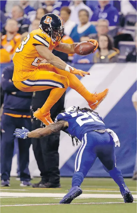  ??  ?? Denver Broncos running back Devontae Booker hurdles over Indianapol­is Colts free safety Clayton Geathers Thursday night during Denver’s 25-13 victory at Lucas Oil Stadium in Indianapol­is. — AP