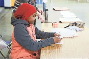  ?? CITY OF MINNEAPOLI­S ?? Minneapoli­s student Miski Mohamed works at a polling place Jan. 21.