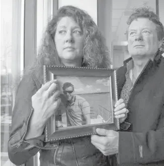  ??  ?? Margie and Mark Gray hold a picture of their son, Myles Gray, 33, who was killed during an altercatio­n with Vancouver police on Aug. 13 last year.