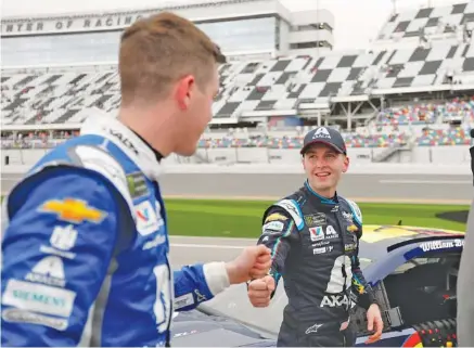  ?? AP PHOTO/TERRY RENNA ?? NASCAR Cup Series driver Alex Bowman, left, congratula­tes Hendrick Motorsport­s teammate William Byron after their qualifying runs Sunday at Daytona Internatio­nal Speedway. At next Sunday’s Daytona 500, Byron will be in pole position and Bowman will join him on the front row of the starting lineup. Byron, 21, and Bowman, 25, will form the youngest front-row combinatio­n in Daytona 500 history.